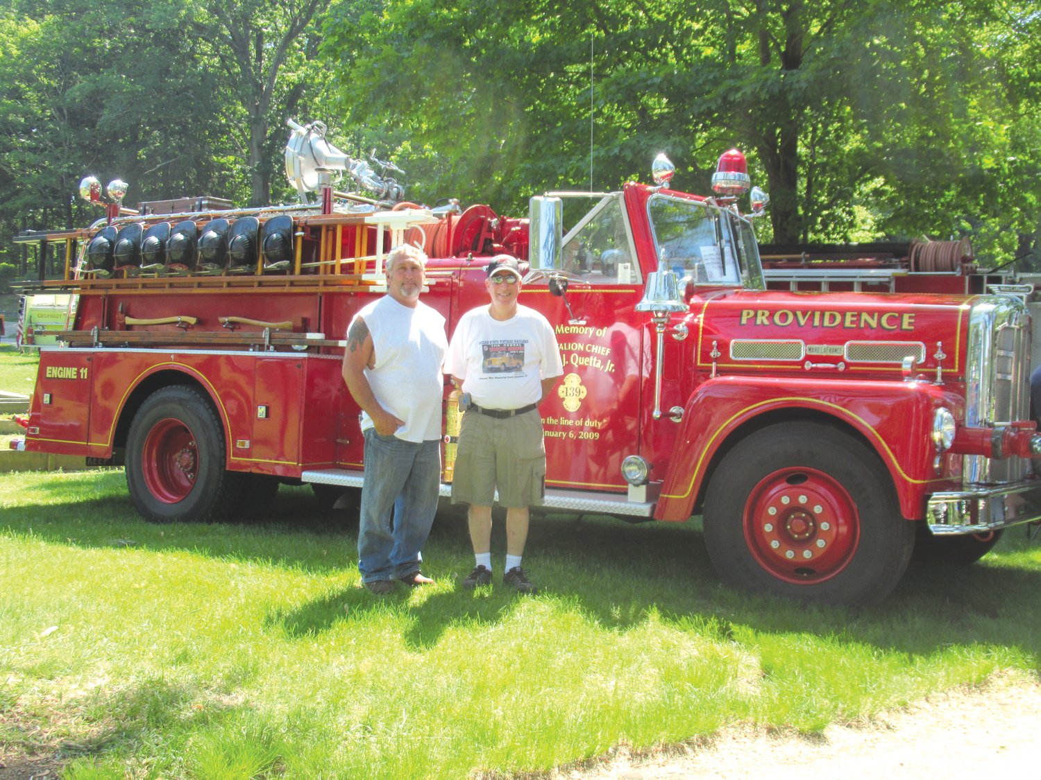 SPECIAL SHOWPIECE: Richard Quetta, who owns this restored 1957 Ward LaFrance antique truck that serves as a memorial to his late brother Frank J. Quetta Jr., is joined by Ocean State Vintage Haulers President Joe Pingitore while discussing plans for Sunday’s unique show in Warwick.